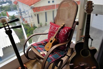 Asoviva Sanshin Rocking Chair with Guitar and Sanshin. The guitar is symbolic of soul music, the music of the people