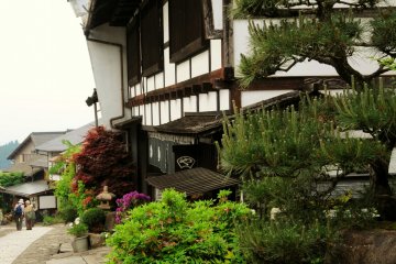 The path is lined with shops, restaurants, and ryokan