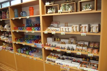 <p>There's a nice little selection of shisha dogs and Ryukyuan stained glass inside Partnerhip Shop and Cafe</p>