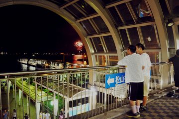 Some people decided to enjoy the show from the department store located in the back area of the port.