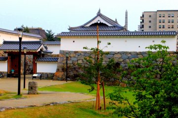 A Japanese garden sits on the right side of the gate.