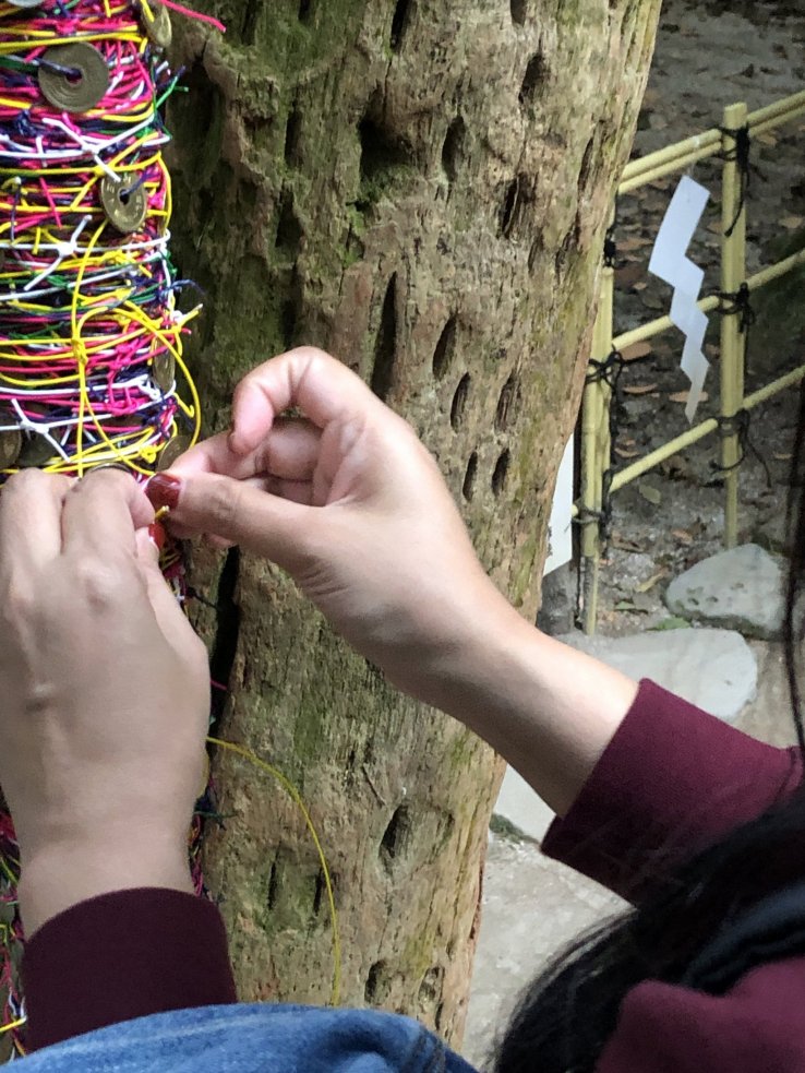 Make a wish! Tying up some lucky coloured string