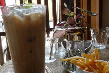 A delicious flavored ice coffee and orange peel snack.