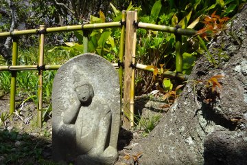 Stone statue under a cherry tree