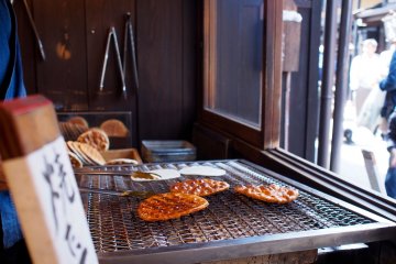 Senbei rice crackers being grilled