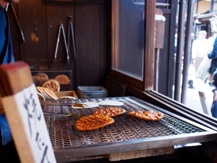 Senbei rice crackers being grilled