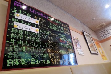 Colorful and fun handwritten menus and promotions on the walls of the restaurant