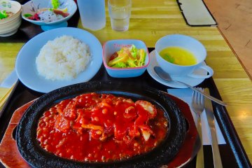 Scalloped pork chops over rice with a special tomato sauce