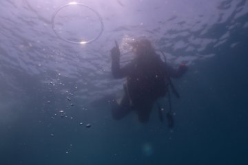 The instructor has fun too. He blows a ring of air towards the sun. 