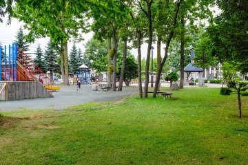 There is plenty of grass space to lay a blanket in the park, most of which is covered by trees to provide nice shade