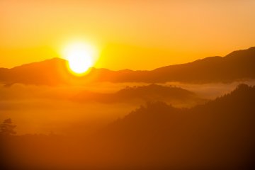 Morning sun shines over the sea of clouds. Emotional scene like this should be captured with backlighting