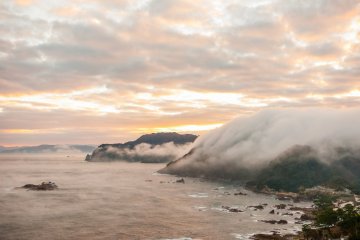 Clouds pool in between mountains, then overflow the ridge line and flow into the Japan Sea in a single burst