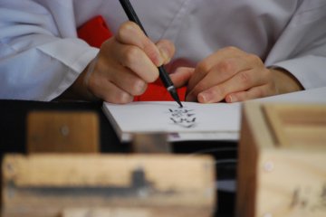 My goshuin getting stamped at Fukuoka's Dazaifu Tenmangu Shrine