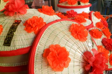 The iconic hanagasa hats with their bright red flowers.