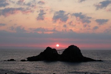 The sun setting between the rocks on the summer solstice in June.