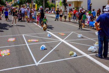 Children enjoying a game of "Roll the potato" to win a prize