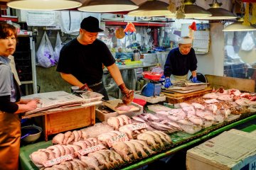 Vendors carefully prepare the fresh seafood for the mostly local customers