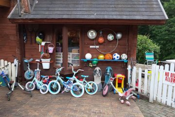 Outside, you can see all the bikes and balls lined up. There is no extra charge to use these. There is also a playground, ping pong and basketball hoops.