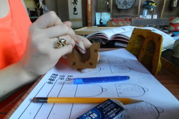 Carving the design out of the mould.