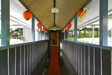 Lanterns line the walkway between buildings.