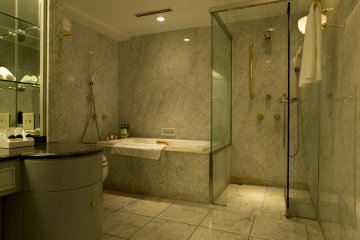 Deluxe rooms leave behind the more common plastic hotel bathroom for lavished marble