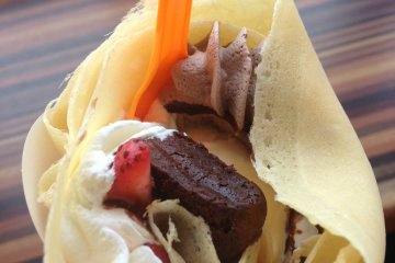 <p>Blue Seal's crepes are stuffed then rolled like an ice cream cone. This crepe contains vanilla ice cream, various whipped creams, strawberries, and chocolate cake</p>