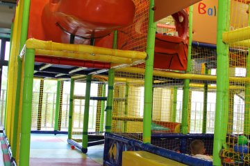 <p>The colorful play park has many different entrance and exit points, ball pits, slides of various types, and rubber matting and padding everywhere</p>