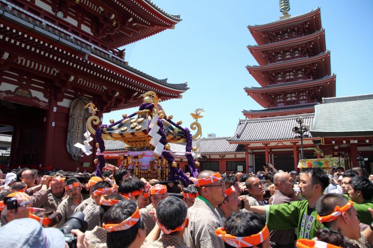 Festival goers carrying a mikoshi