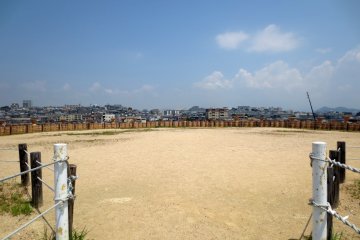 <p>The head of the keyhole tomb surrounded by haniwa is a large open area overlooking the surrounding town of Tarumi</p>