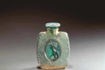 A perfume bottle decorated with fern leaf designs