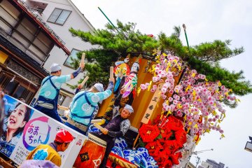 At the front of the float the children play the Taiko drums and at the back the adults play larger drums