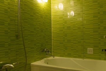 <p>A modern bathroom with a Jacuzzi style bath tub</p>