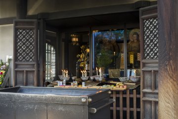 Two of the Okotsu Butsu and the offering people have placed before them at Isshinji Tennoji