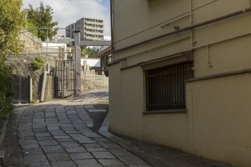 Located seemingly to the rear of a house is a small temple and cemetery