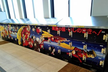 A row of lockers is decorated with characters from the manga/anime Cyborg009.  See more of them at the manga museum in Ishinomaki City.