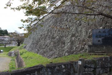 Huge castle wall bordering the parking lot