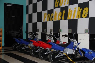 <p>The pocket-bikes aren't fast by street standards, but are a swift ride when navigating the oval arena on the fifth floor</p>