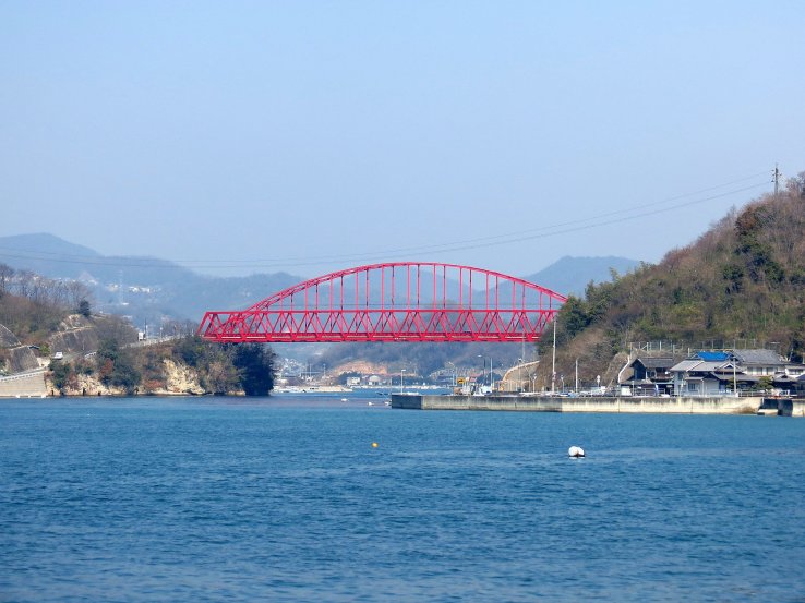 The vibrant red Mukaishima Bridge