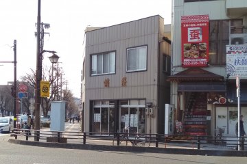 The modern storefront on a corner of a busy intersection