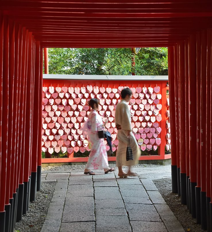 The shrine has heart shaped ema, plus rows of torii arches