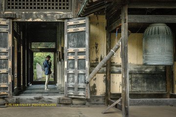 A devotee praying at the Butsuden.