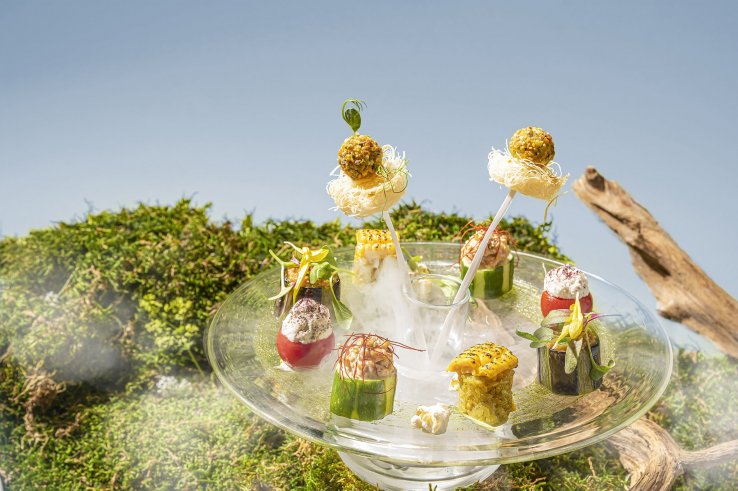 Dry ice creates a mist around the savory plate to emulate the sky