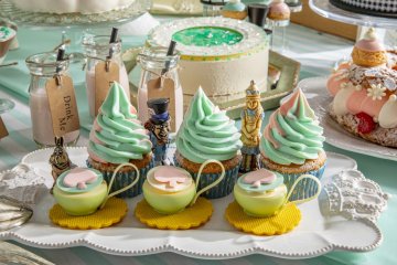 The Alice's Mirror cake can be seen in the background