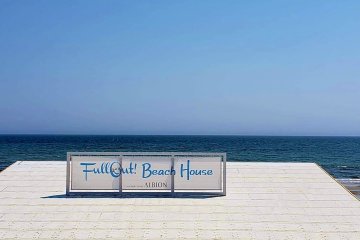 In front of the beach houses, the big blue