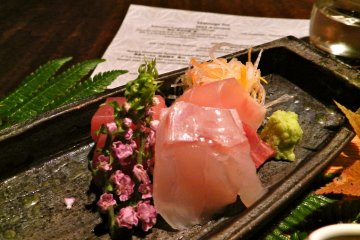 Amazing sashimi served in a little tiny boat.