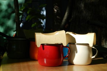 Adorable little tin cups of coffee.