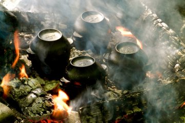 The cast iron pots with the apples cooking inside.