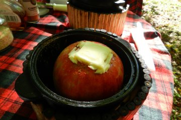 Yes, that is a wedge of butter stuffed into that apple.