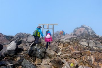 When people reach the summit, they go through this torii, a Shinto gate
