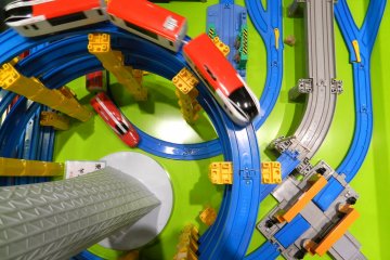 <p>A train runs on a track that loops around a model of Tokyo Skytree.</p>